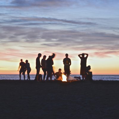 Group of people on the beach at sunset