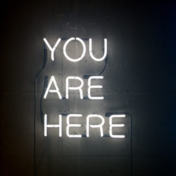 Neon sign with "You Are Here"