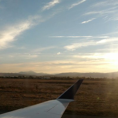 Picture looking out over the wing of a plane before takeoff
